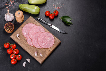 Slices of delicious fresh sausage on a wooden cutting board
