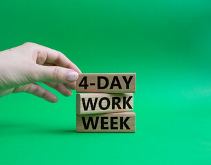 4-day work week symbol. Concept words 4-day work week on wooden blocks. Beautiful green background. Businessman hand. Business and 4-day work week concept. Copy space