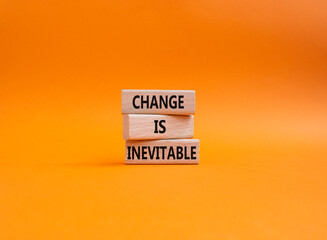 Change is Inevitable symbol. Wooden blocks with words Change is Inevitable. Beautiful orange background. Business and Change is Inevitable concept. Copy space.