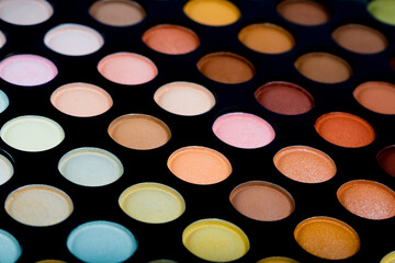 Obraz na płótnie Canvas Eye shadow and skin correctors set close-up. Makeup palette. Samples of various cosmetics from a professional makeup artist.
