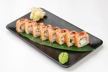 Sushi philadelphia on black plate and white background