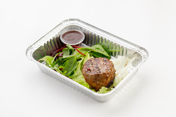 Grilled beef arranged in a tray with sauce on a white background