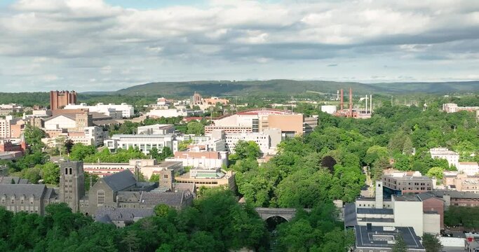 Late afternoon summer scenic aerial video of Ithaca NY, College Town.