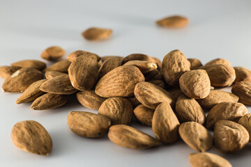 pile of healthy almonds on gray background