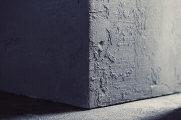 Concrete cube on abstract cement background texture. Wall corner of house