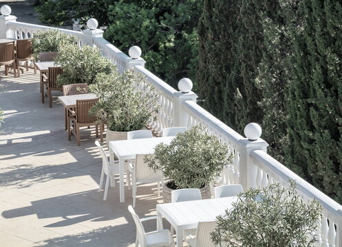 Summer cafe on a beautiful white terrace in the park