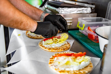 process of preparing traditional greek fast food - gyros. chef hand cooking food