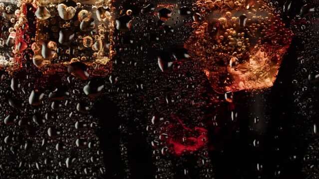 Cold lemonade in glass close-up. Cola with ice macro shooting texture. Refreshing cocktail.