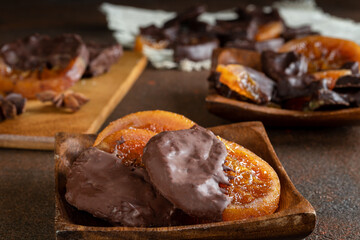 Candied oranges with chocolate. Dryed oranges and cinnamon.