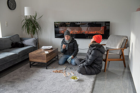 Family at home in winter clothes it's cold they freeze save energy