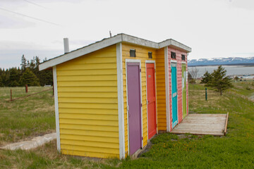 Fototapeta na wymiar Colourful outhouses along a hike in Cows Head Newfoundland