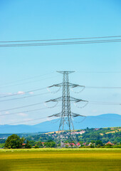 Electric pole power lines outgoing electric wires againts on cloud blue sky.