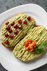 Close up of Avocado toast on a whole grain sandwich. Avocado puree. The concept of healthy food, diet, vegan, vegetarian food