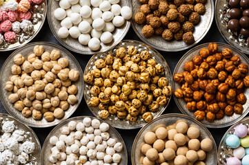 Assortment of roasted chickpeas on dark rustic table, turkish traditional nuts, leblebi