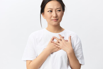 Heart attack. Suffering from pain tanned beautiful young Asian woman hold hand on chest heart crying posing isolated on white background. Injuries Poor health Illness concept. Cool offer Banner