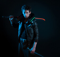 A guy in a cyberpunk image. Cyborg samurai holds a tuned sword in his hands. A young man in neon...
