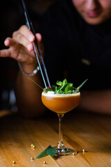 Brown chocolate alcoholic cocktail with fresh mint. Cocktail on the background of the bar.