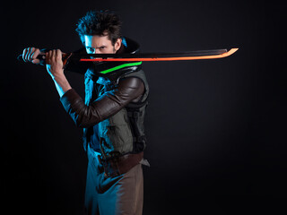 A guy in a cyberpunk image. Cyborg samurai is preparing to attack using a tuned sword. A young man in neon lighting on a black background