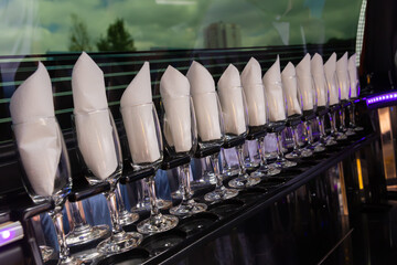 Wine glasses in the limousine with paper napkings inside.