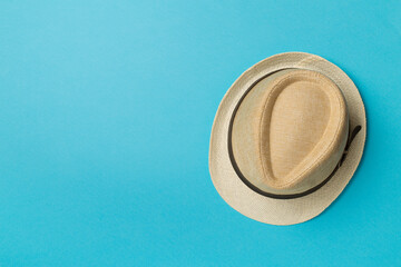 Straw hat on color background, top view
