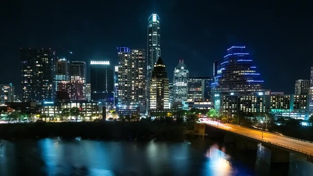 Timelapse of Downtown Austin Texas skyline at night with view of the Colorado river