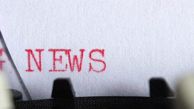 Typing "breaking news" on an old electric typewriter