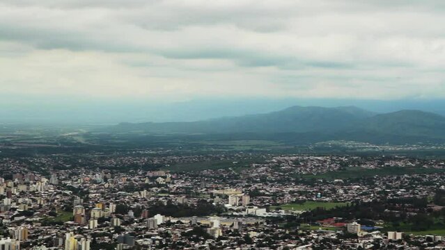 Cityscape. Panning the city of Salta in Argentina. View of the buildings and surrounding mountains in a cloudy day. 