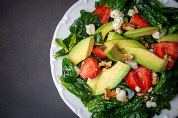 Healthy diet salad; Strawberry Spinach Salad with Avocado.