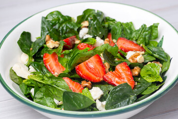 Healthy diet salad; Strawberry Spinach Salad with Avocado.