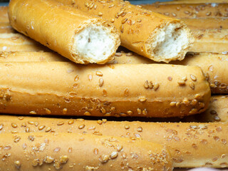Sesame biscuits on a white background. Biscuits are elongated in the form of sticks. Bread products. Flour products. Lots of homemade cakes. Healthy food.
