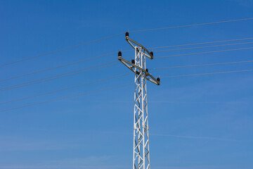 Electric support of high voltage power cables. Metal pole with high voltage wires and glass...