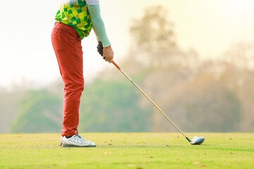 Golf ball and golf club in beautiful golf course at sunset background. sport concept.