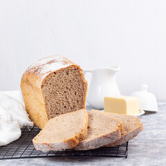 Slices of homemade no knead sandwich bread on cooling rack, square format
