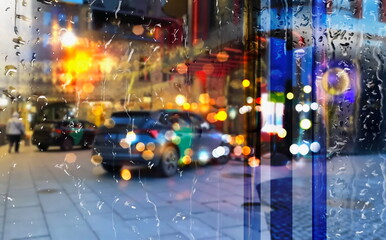  rain drops on building  windows   rainy evening city street traffic car blurred light at night