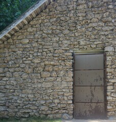 old stone wall with door
