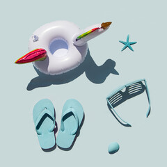 Minimalistic beach concept. Sea symbols idea. Sunglasses, flip flops, starfishes and seashell on pastel blue background. Creative summer concept. Holiday composition. Flat lay.