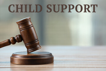 Judge's gavel on white wooden table. Child support concept