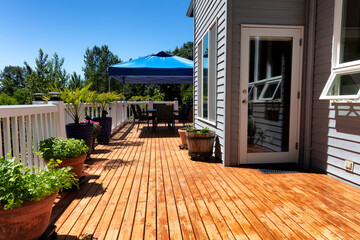Home wood deck with outdoor furniture and garden backyard - obrazy, fototapety, plakaty