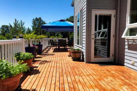 Home wood deck with outdoor furniture and garden backyard