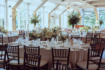 Luxury Beautiful Stylish Romantic Greens and Whites Fresh Flower decorations of guest tables at the wedding venue dinner celebration set up