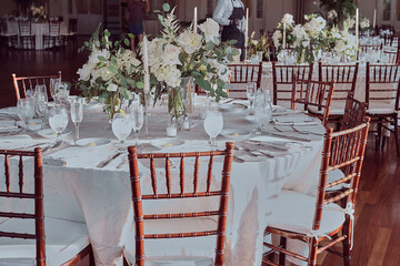 Luxury Beautiful Stylish Romantic Greens and Whites Fresh Flower decorations of guest tables at the wedding venue dinner celebration set up
