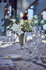 Luxury Beautiful Stylish Romantic Greens and Whites Fresh Flower decorations of guest tables at the wedding venue dinner celebration set up