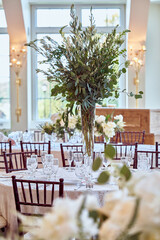 Luxury Beautiful Stylish Romantic Greens and Whites Fresh Flower decorations of guest tables at the wedding venue dinner celebration set up