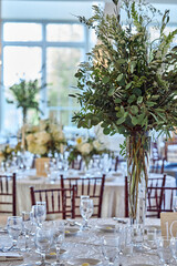Luxury Beautiful Stylish Romantic Greens and Whites Fresh Flower decorations of guest tables at the wedding venue dinner celebration set up