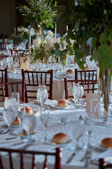 Luxury Beautiful Stylish Romantic Greens and Whites Fresh Flower decorations of guest tables at the wedding venue dinner celebration set up