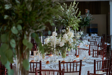 Luxury Beautiful Stylish Romantic Greens and Whites Fresh Flower decorations of guest tables at the wedding venue dinner celebration set up