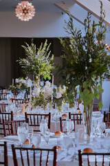 Luxury Beautiful Stylish Romantic Greens and Whites Fresh Flower decorations of guest tables at the wedding venue dinner celebration set up