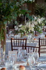 Luxury Beautiful Stylish Romantic Greens and Whites Fresh Flower decorations of guest tables at the wedding venue dinner celebration set up