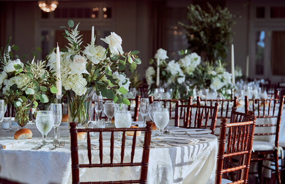 Luxury Beautiful Stylish Romantic Greens and Whites Fresh Flower decorations of guest tables at the wedding venue dinner celebration set up