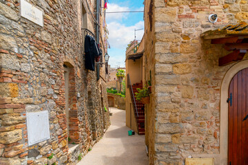  A narrow stone alley in the hill town of Volterra, Italy.